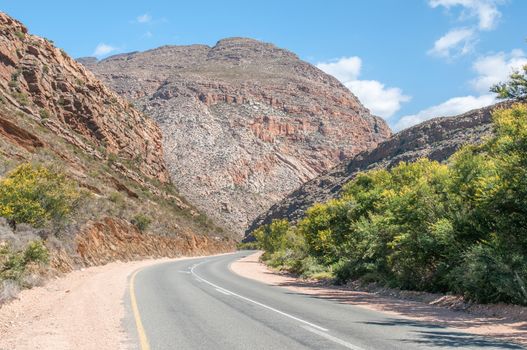 Meiringspoort where the road follows a scenic route cut by the Groot River through the  Swartberg (Black Mountain), crossing the river 25 times