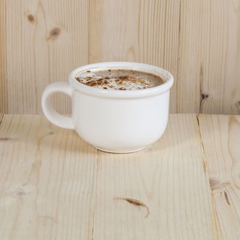 Hot coffee cup on wood 