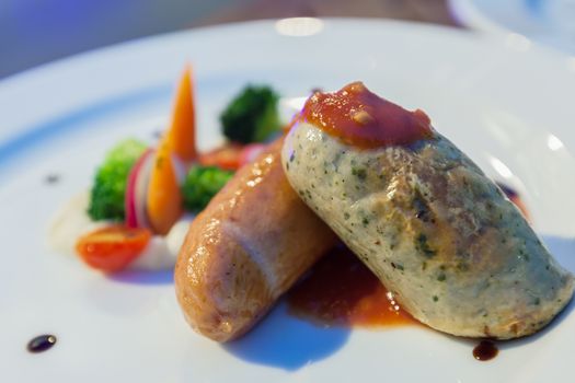 Grilled Mixed German Sausages on white plate for Main Dishes