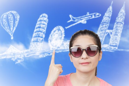 Conceptual image of Asian woman smiling and wearing glasses, finger point up, thinking about travel choice with blue cloud sky background