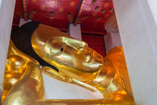 Golden Buddha statue, the largest reclining Buddha image in temple names "Wat Phra Non Chakkrasi Worawihan" at Singburi, Thailand can use religious concept background