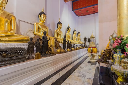 Golden Buddha statue sit  respectively in temple names "Wat Phra Non Chakkrasi Worawihan" at Singburi, Thailand,can use religious concept background