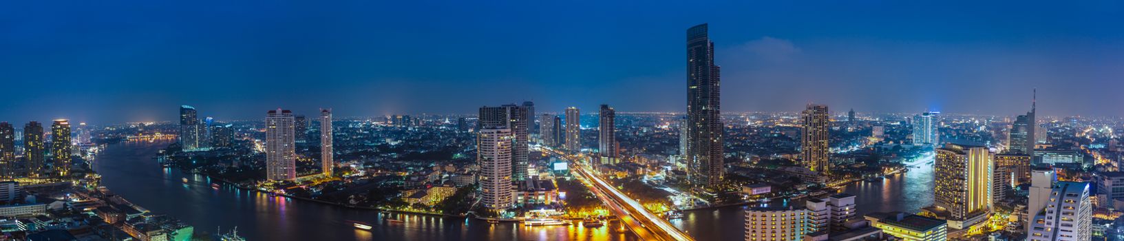 Business Building Bangkok city area at night life with transportation car and ship as panorama, high angle bird eyes view