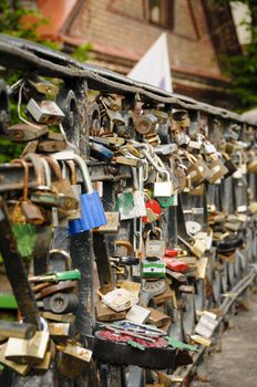 Love locks on a bridge railing in Vilnius, Lithuania, Europe