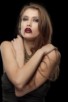 Portrait of a pale gothic vampire woman on a black background