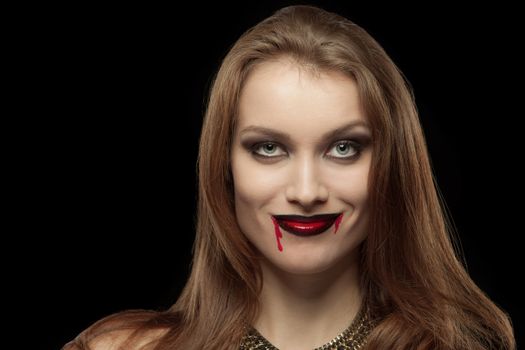 Close-up portrait of a pale gothic vampire woman on a black background