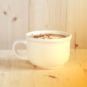 cup of coffee on brown background
