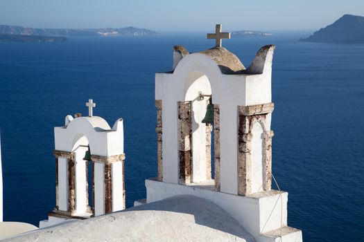 Blue domes and their bell tower in Oia. Santorini