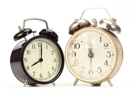 new and old broken alarm clocks over white