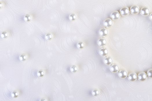 White pearls necklace on white paper background