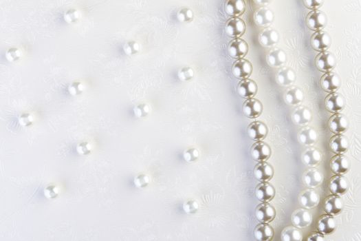 White pearls necklace on white paper background