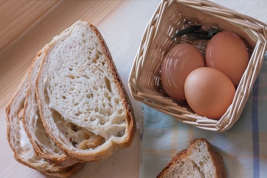 photograph depicting eggs in the basket and sliced bread