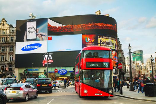 LONDON - APRIL 12: Piccadilly Circus junction crowded by people on April 12, 2015 in London, UK. It's a road junction and public space of London's West End in the City of Westminster, built in 1819.