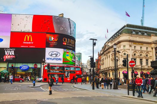 LONDON - APRIL 12: Piccadilly Circus junction crowded by people on April 12, 2015 in London, UK. It's a road junction and public space of London's West End in the City of Westminster, built in 1819.