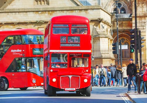 LONDON - APRIL 12: Iconic red double decker bus on April 12, 2015 in London, UK. The London Bus is one of London's principal icons, the archetypal red rear-entrance Routemaster recognised worldwide.
