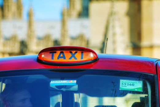 LONDON - APRIL 12: Famous taxi cab (hackney) on a street on April 12, 2015 in London, UK. A hackney or hackney carriage (a cab, black cab, hack or London taxi) is a carriage or automobile for hire.