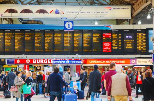 LONDON - APRIL 12: People at the Victoria station on April 12, 2015 in London, UK. Station, generally known as Victoria, is a central London railway terminus and London Underground complex named after Victoria Street.