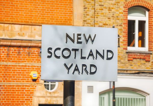LONDON - APRIL 12: Famous New Scotland Yard sign on April 12, 2015 in London, UK. It's a metonym for the headquarters of the Metropolitan Police Service, the territorial police force of London.