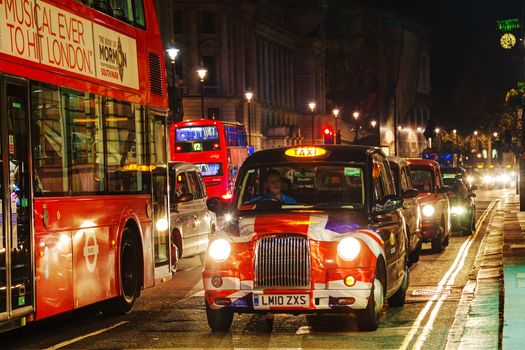 LONDON - APRIL 14: Famous taxi cab (hackney) on a street on April 14, 2015 in London, UK. A hackney or hackney carriage (also called a cab, black cab, hack or London taxi) is a carriage or automobile for hire.