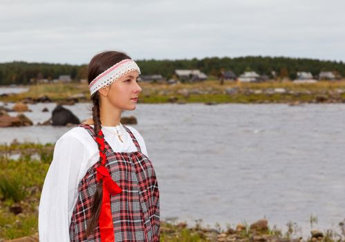 Pomorian girl in national dress is waiting for the return of the groom from the voyage