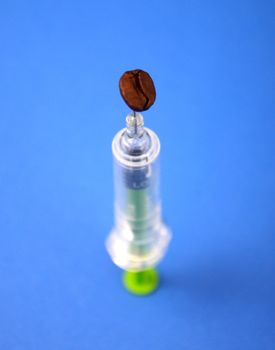 Coffee adiction, picture of a coffee beans and syringe