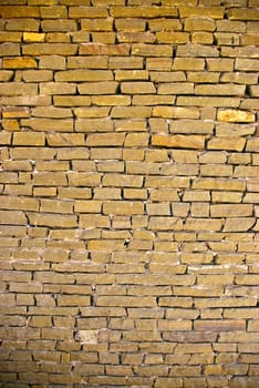 The grunge olden colored brick wall texture