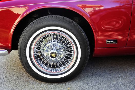 Spoked wheel of a Jaguar XJ photographed gathering of old cars Town Hall Square in the town of Ales, in the Gard department