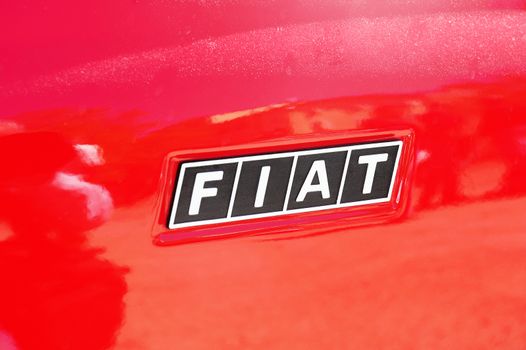 Logo Fiat on the Fiat Fiat 500 a red photographed gathering old Town Hall Square cars in the city of Ales in the Gard department