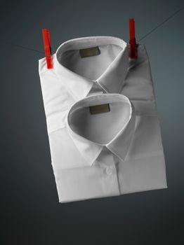 white shirt over gray background with pin

