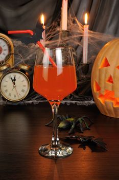 A glass of drink on the table in honor of Halloween