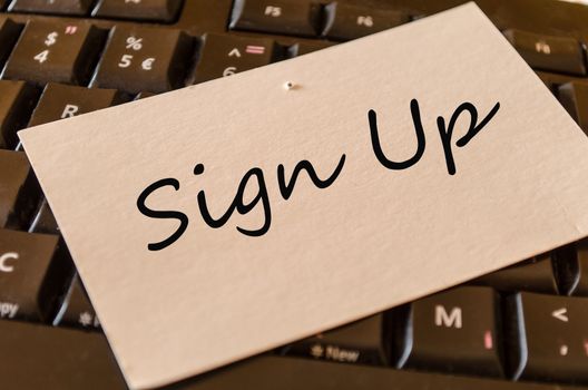 Sign up Concept on black keyboard note