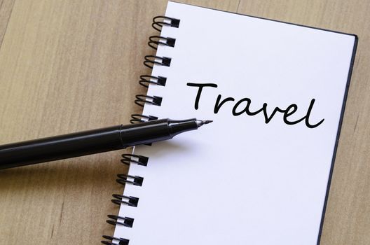 White notepad and ink pen on the wooden desk Travel Concept