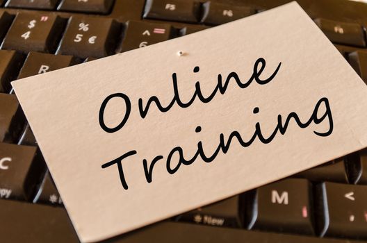 Online training Concept on black keyboard
