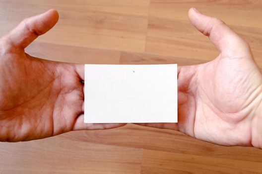 Man hands hold note with wood table office background