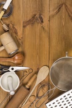 A selection of Kitchen Utensils on a farmhouse kitchen table - with Space for Text