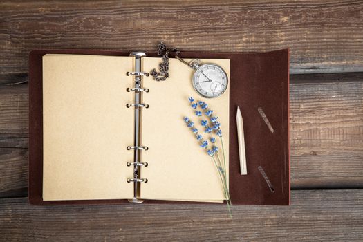 Vintage grunge still life with pocket watch, lavender flower and old book.