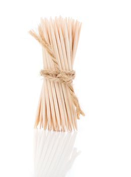 Bunch of brown toothpicks on white background