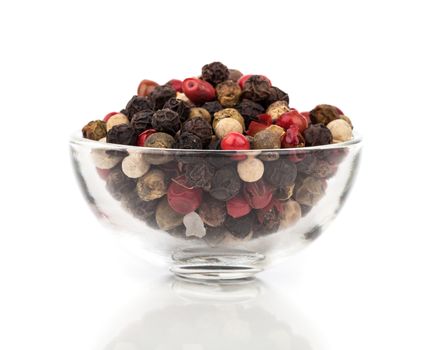 Colored Pepper in a glass bowl isolated on white background