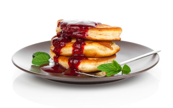 Delicious pancakes with raspberries sauce isolated over white background.
