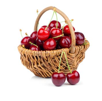 Basket full of fresh red cherry on a white background