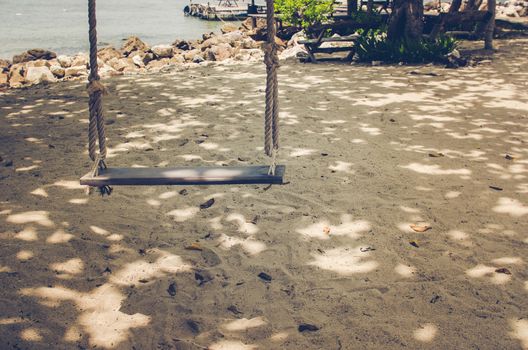 swing on beach sand and sea in Koh Samet Thailand vintage