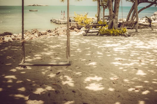 swing on beach sand and sea in Koh Samet Thailand vintage