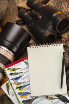 Birdwatching - Binoculars, camera, bird books and a notebook and pen - Space for text