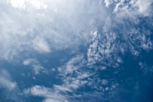 The soft white clouds against blue sky