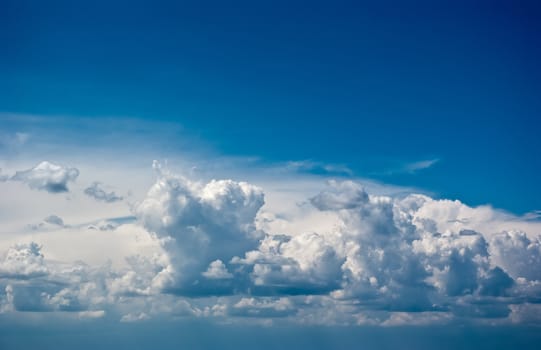 The soft white clouds against blue sky