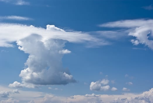 The soft white clouds against blue sky