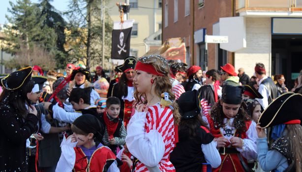 Poggio Renatico, Italy - 01 march 2015: The parade of carnival floats with dancing people on streets. a pirate parade in head horde