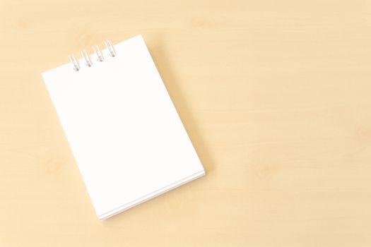 White Small Notebook with Blank Cover on Wooden Brown Table