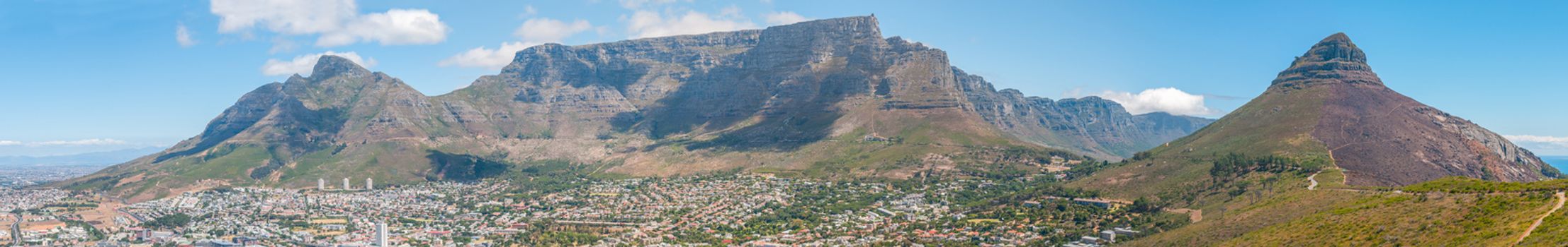 CAPE TOWN, SOUTH AFRICA - DECEMBER 18, 2014: Panoramic view of part of the city, Devils Peak, Table Mountain, Twelve Apostles and Lions Head. The lower and upper cable stations are visible.