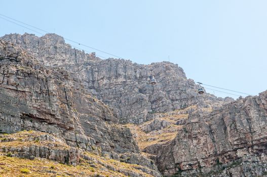 CAPE TOWN, SOUTH AFRICA - DECEMBER 18, 2014:  The two cable cars about to pass by each other on Table Mountain cableway